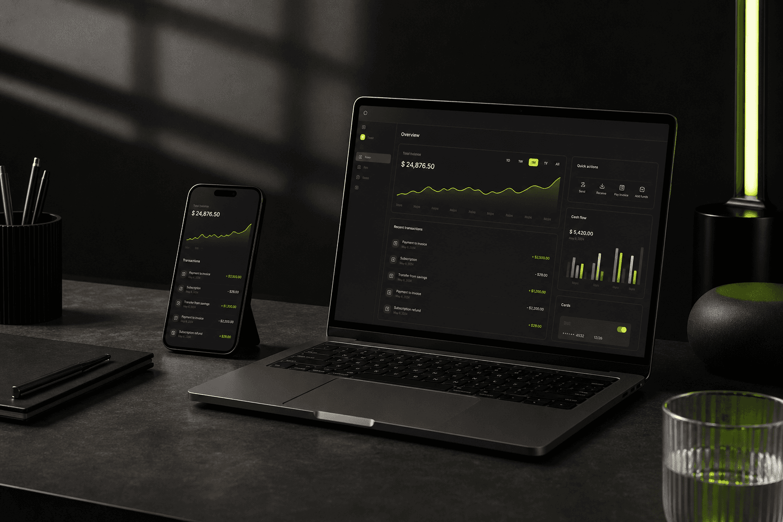 Premium laptop and smartphone displaying a dark digital finance product